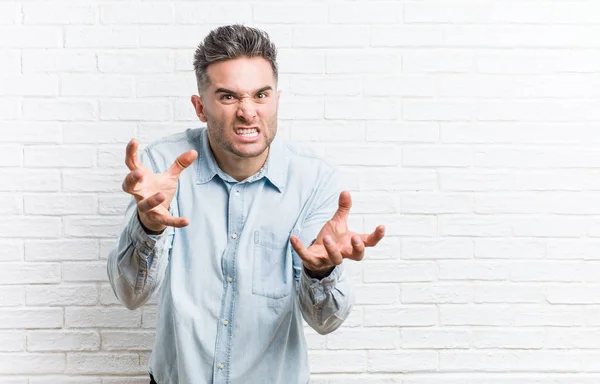 Young Handsome Man Bricks Wall Upset Screaming Tense Hands — Stock Photo, Image