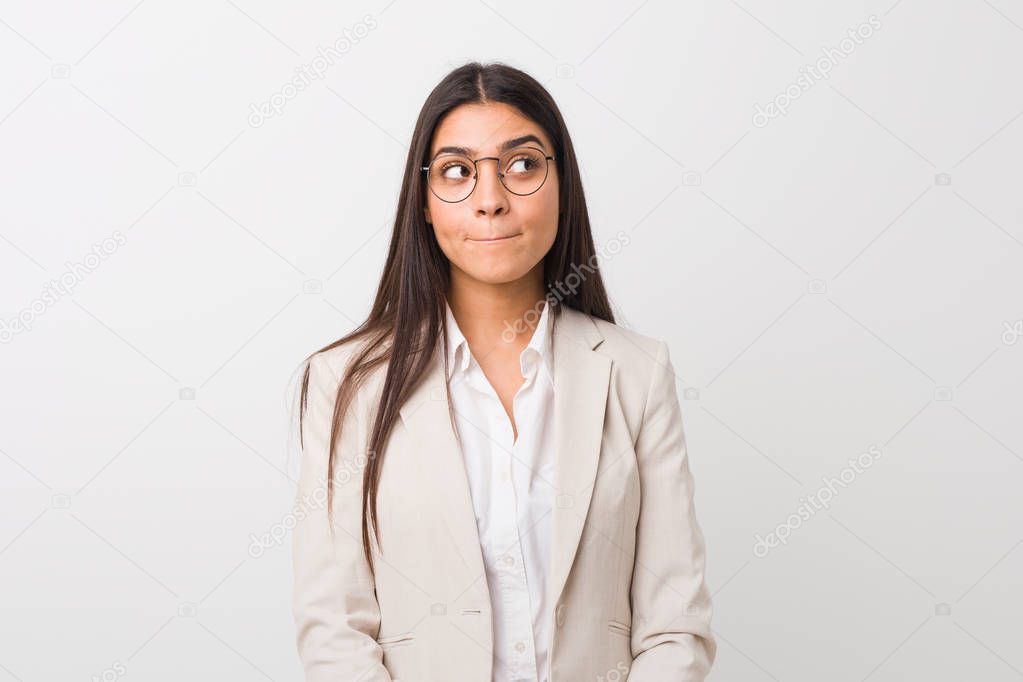 Young business arab woman isolated against a white background confused, feels doubtful and unsure.