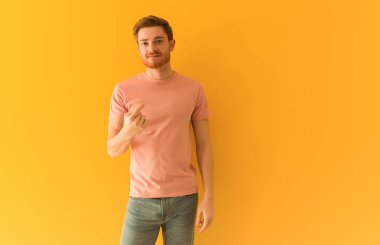 Genç kızıl saçlı adam gelmeye davet ediyor