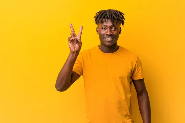 Young Black Man Wearing Rastas Yellow Background Joyful Carefree Showing — Stock Photo, Image