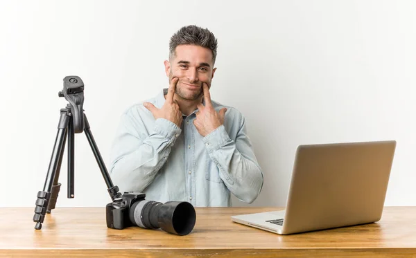 Young handsome photography teacher doubting between two options.