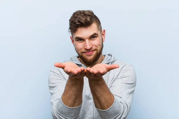 Jovem Homem Fitness Bonito Segurando Algo Com Palmas Das Mãos — Fotografia de Stock