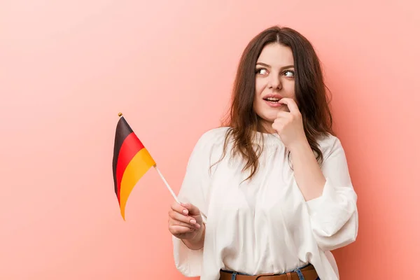 Young Curvy Size Woman Holding Germany Flag Relaxed Thinking Something — 스톡 사진