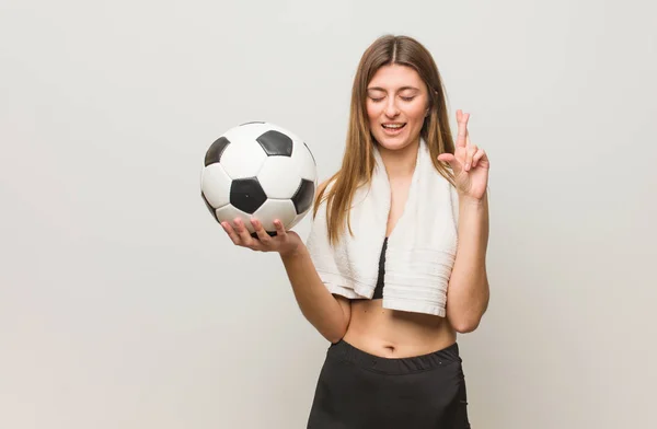 Young Fitness Russian Woman Crossing Fingers Having Luck Holding Soccer — Stock Photo, Image