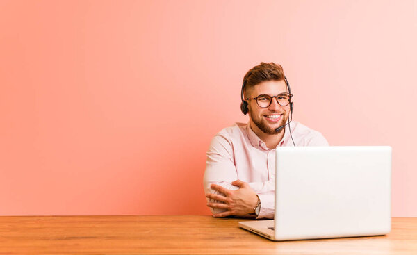 Young man working in a call center who feels confident, crossing arms with determination.