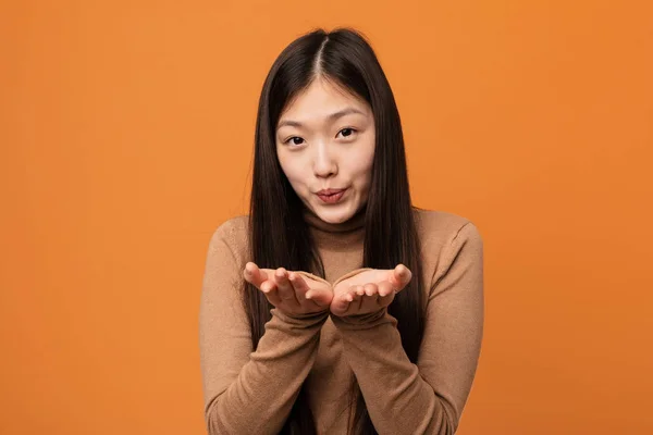 Young Pretty Chinese Woman Folding Lips Holding Palms Send Air — 스톡 사진