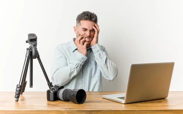 Young handsome photography teacher whining and crying disconsolately.