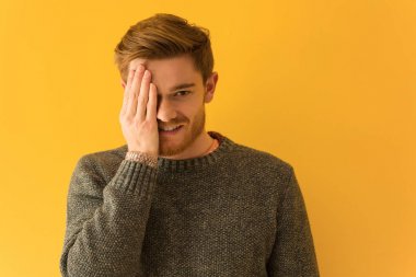 Genç kızıl saçlı adam bağırarak yüzünü kapatıyordu.