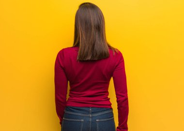 Arkadan bakan entelektüel genç bir kadın.