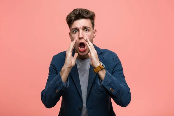 Young business natural man shouting excited to front.