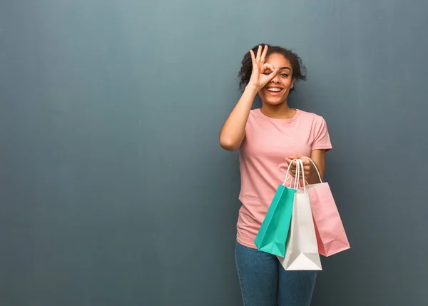 Young Black Woman Confident Doing Gesture Eye She Holding Shopping — 스톡 사진