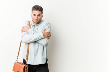 Young handsome business man going cold due to low temperature or a sickness.