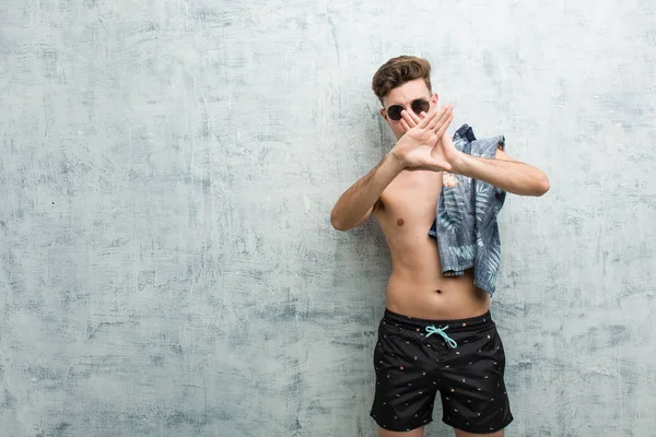Young Caucasian Man Wearing Swimsuit Doing Denial Gesture — Stock Photo, Image