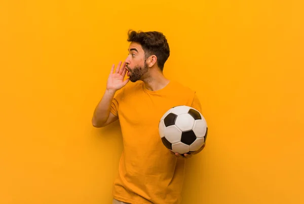 Young soccer player man whispering gossip undertone