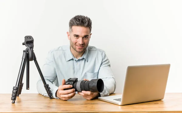 Young handsome photography teacher happy, smiling and cheerful.