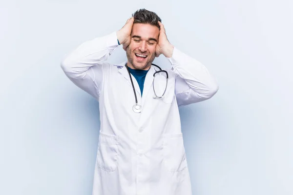 Young Handsome Doctor Man Laughs Joyfully Keeping Hands Head Happiness — 스톡 사진