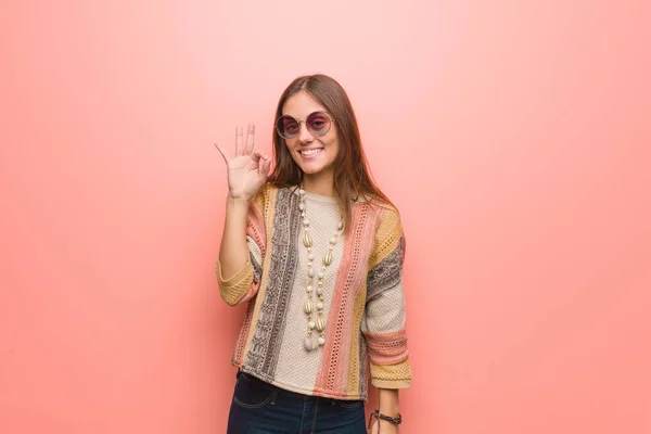 Young hippie woman on pink background cheerful and confident doing ok gesture