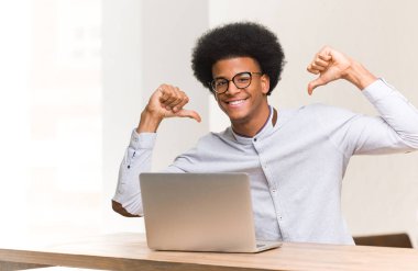 Genç siyahi adam dizüstü bilgisayarını kullanıyor, örnek olarak...