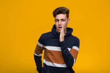 Kapüşonlu genç adam gizli bir sıcak fren haberinden bahsediyor.