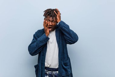 Genç Afrikalı siyah adam pijama giyip sızlanıyor ve ağlıyordu..