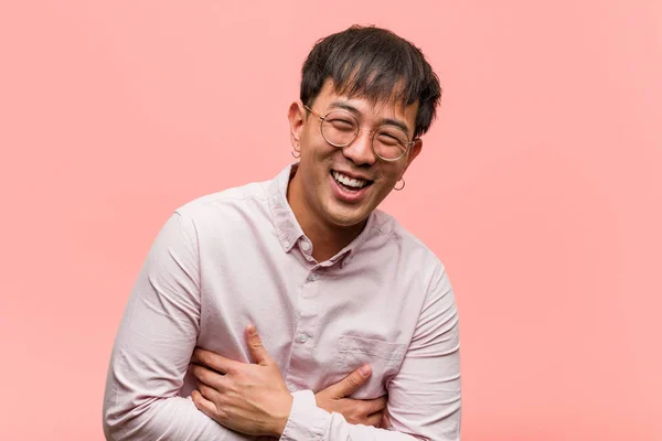 Young chinese man laughing and having fun