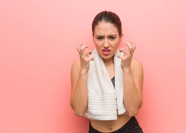 Young fitness woman angry and upset