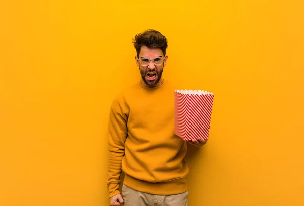 Young Man Holding Popcorns Screaming Very Angry Aggressive — Stock Photo, Image