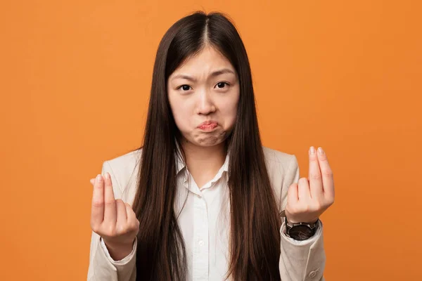 Young business chinese woman showing that he has no money.