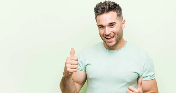 Young Handsome Man Green Background Raising Both Thumbs Smiling Confident — Stock Photo, Image