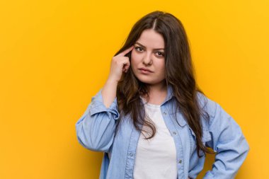 Genç Curvy artı boyutu kadın parmak ile Tapınak işaret, düşünme, bir göreve odaklanmış.