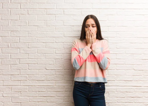 Young modern woman very scared and afraid hidden