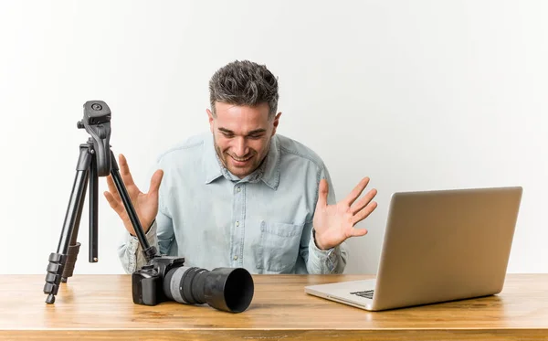 Young handsome photography teacher joyful laughing a lot. Happiness concept.