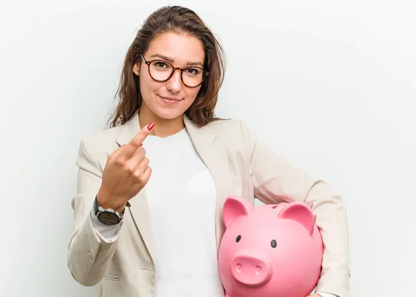 Young European Business Woman Holding Piggy Bank Pointing Finger You — Stock Photo, Image