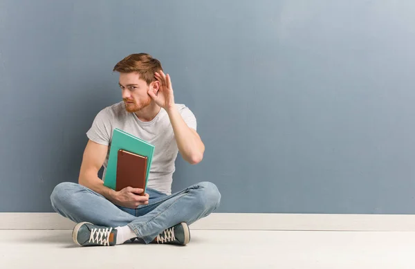 Young Redhead Student Man Sitting Floor Try Listening Gossip Holding — Stock Photo, Image