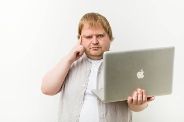 Kafkas artı boyutu adam parmak ile tapınağını işaret eden bir dizüstü tutan, düşünme, bir görev üzerinde duruldu.