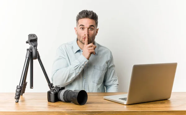 Young handsome photography teacher keeping a secret or asking for silence.