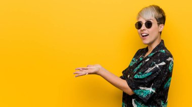 Genç kıvrımlı kadın bir avuç üzerinde bir kopya alanı tutan bir yaz bakmak giyiyor.