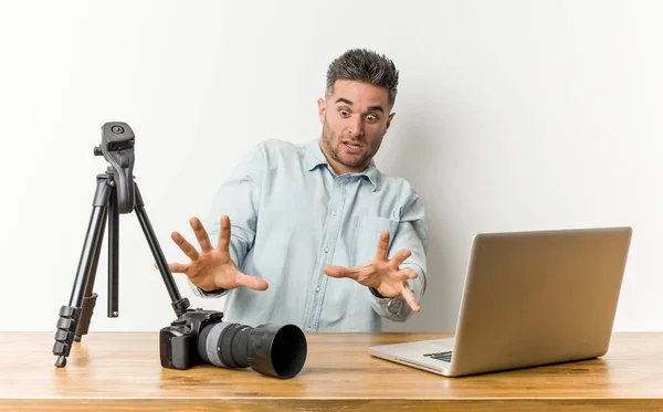 Young handsome photography teacher being shocked due to an imminent danger