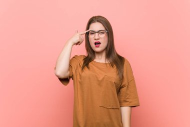 Gözlüklü genç öğrenci kadın parmak gösteriyle bir hayal kırıklığı jest gösteren.