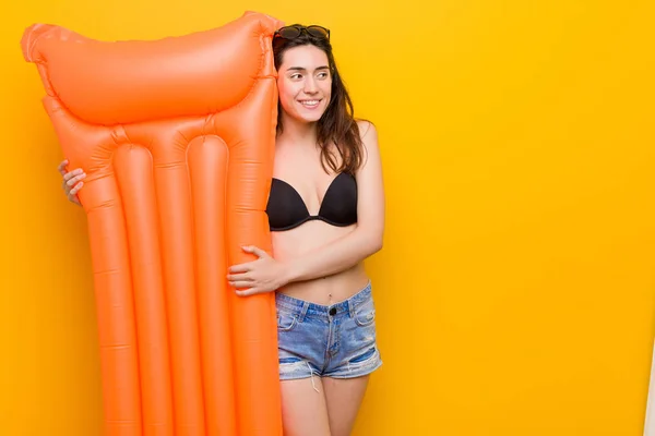 Young caucasian woman holding a float