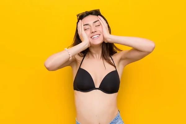 Sarı Arka Plan Karşı Bir Bikini Giyen Genç Esmer Kadın — Stok fotoğraf