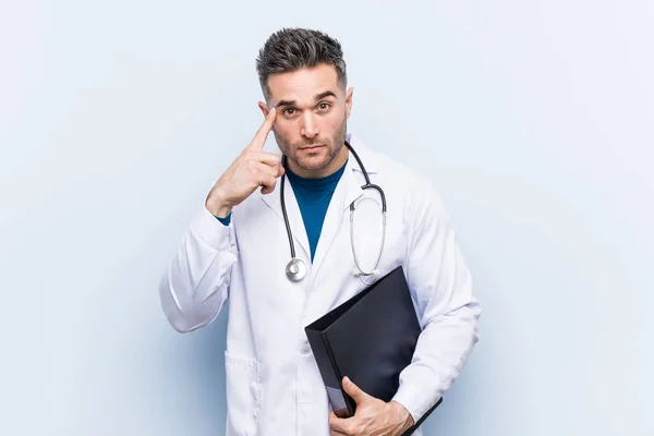 Caucasian Doctor Man Holding Folder Pointing His Temple Finger Thinking — Stock Photo, Image