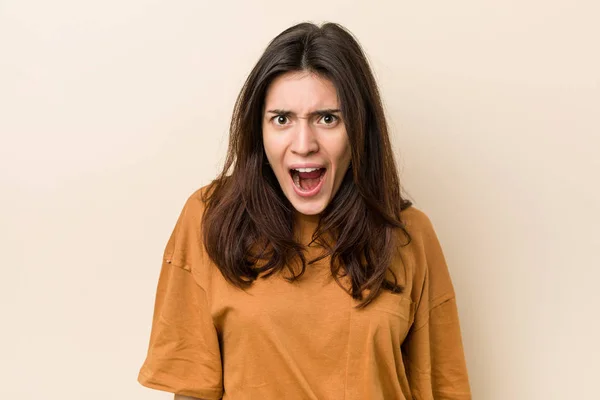 Young Brunette Woman Beige Background Screaming Very Angry Aggressive — Stock Photo, Image