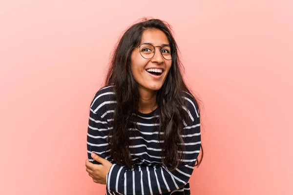 Young intellectual indian woman laughing and having fun.