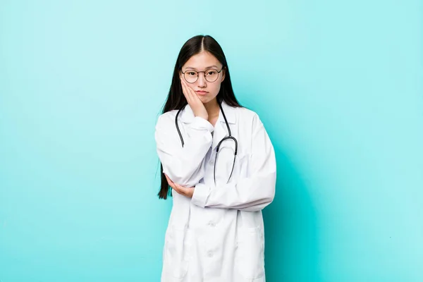 Young chinese doctor woman who is bored, fatigued and need a relax day.