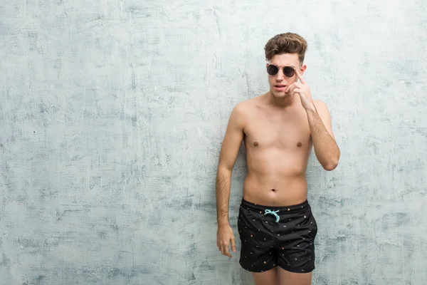 Young Caucasian Man Wearing Swimsuit Showing Disappointment Gesture Forefinger — Stock Photo, Image