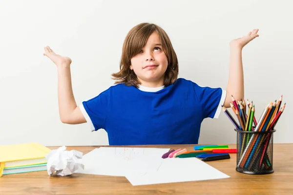 Little Boy Painting Doing Homeworks His Desk Confused Doubtful Shrugging — Stock Photo, Image