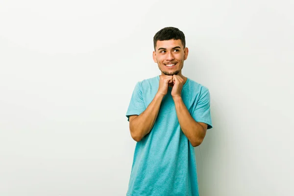 Young Hispanic Man Keeps Hands Chin Looking Happily Aside — Stock Photo, Image