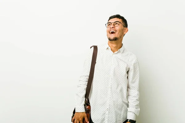 Young hispanic casual business man relaxed and happy laughing, neck stretched showing teeth.