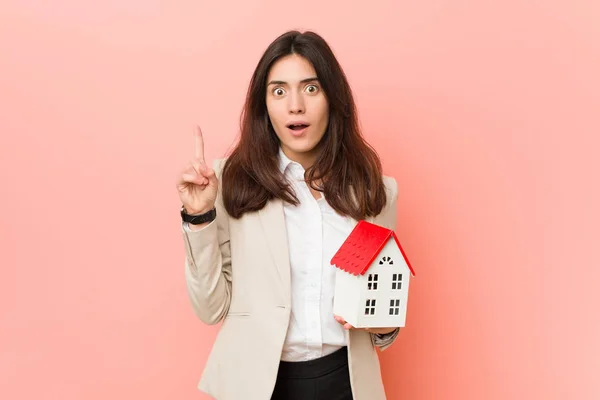Young Caucasian Woman Holding House Icon — Stock Photo, Image